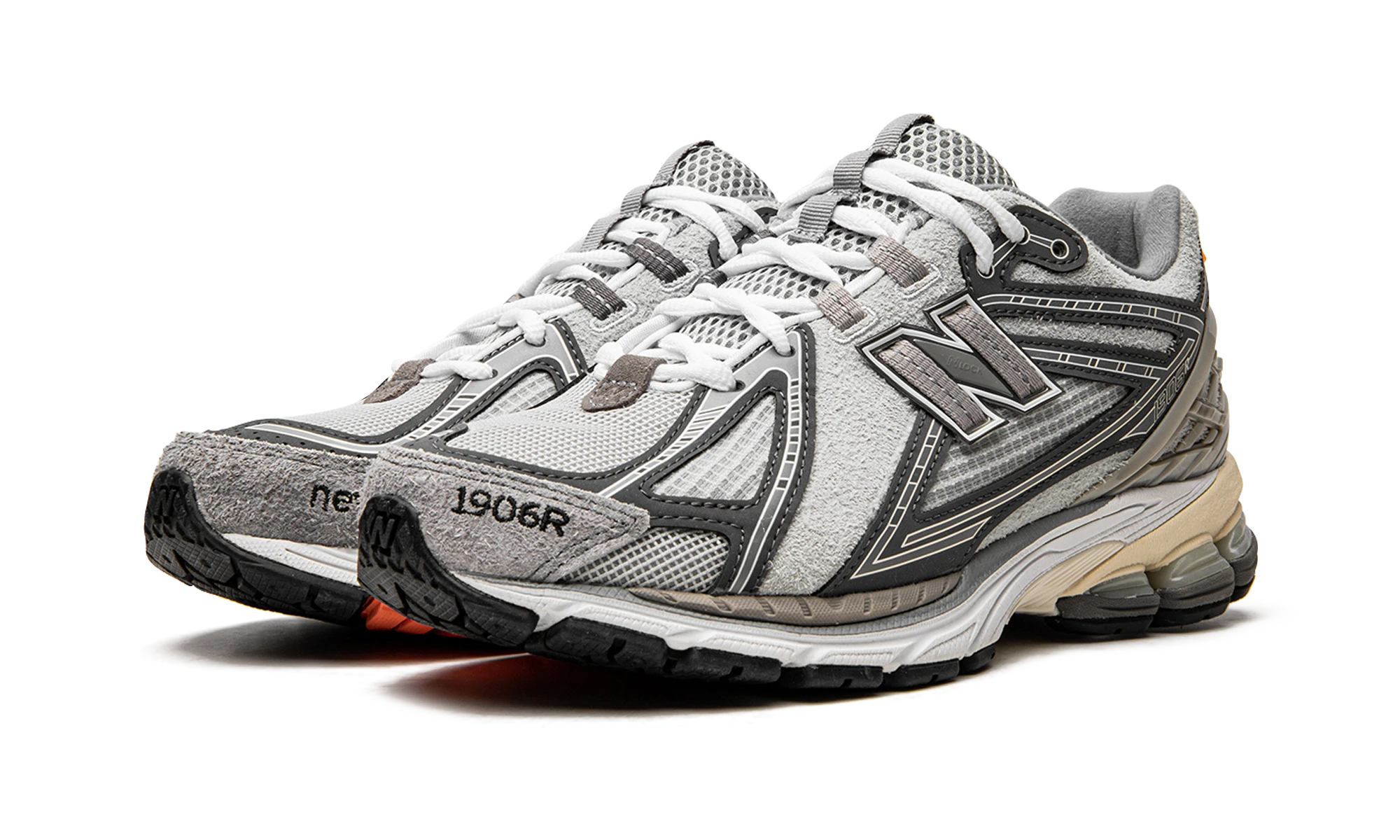 Vue de face de la paire de sneakers New Balance 1906R N.Hoolywood x INVINCIBLE Grey Swan gris, orange et blanc.